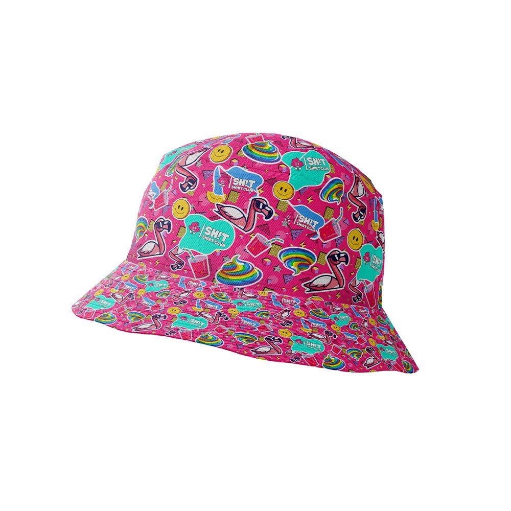 The Badass Bucket Hat features a bright pink background with playful smiley faces, rainbows, flamingos, and speech bubbles. Its wide brim and bold, fun design make it the perfect festival hat for any event.