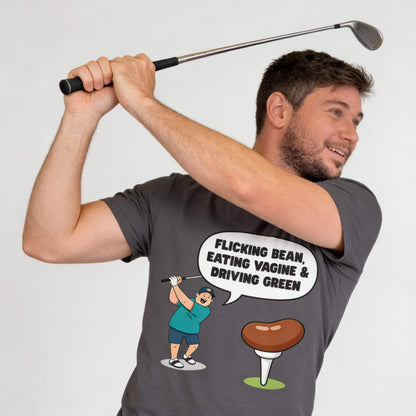 A man poses as if swinging a golf club, wearing the "Flicking Bean, Eating Vagine & Driving Green" Tee, which features a cartoon golfer, speech bubble with the slogan, and a golf tee topped with a bean.