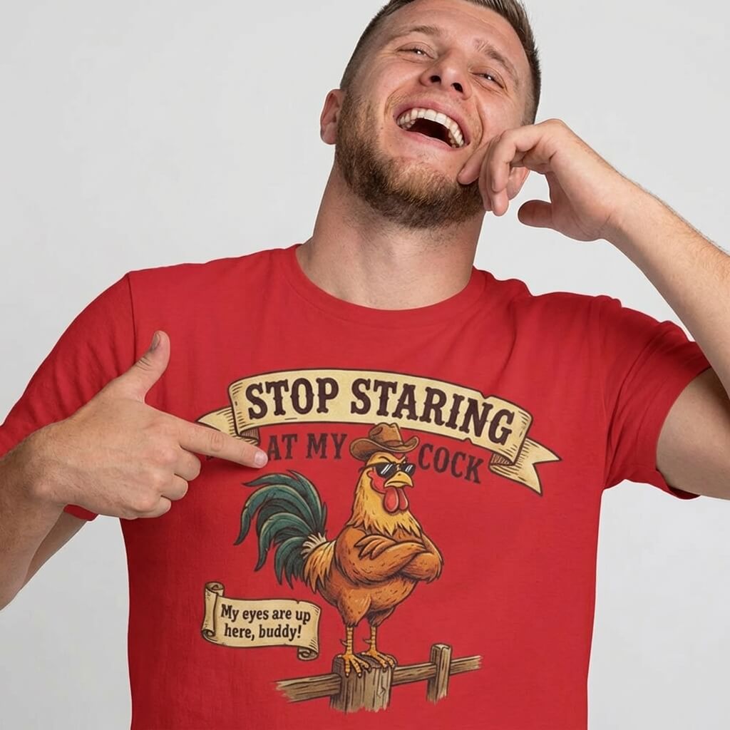 A man laughs and points at his Stop Staring at My Cock Stag Do Tee, featuring a cartoon rooster in a cowboy hat and cheeky text—ideal as a funny stag party or groom t-shirt for any bachelor bash.