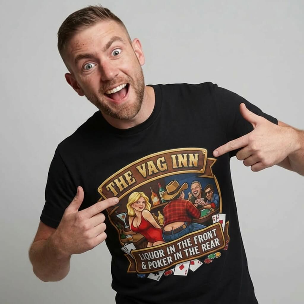 A smiling man with short hair and a beard points at his black The Vag Inn Stag Do Tee, featuring a cartoon bar scene—perfect as a stag do t-shirt or funny pub crawl shirt.