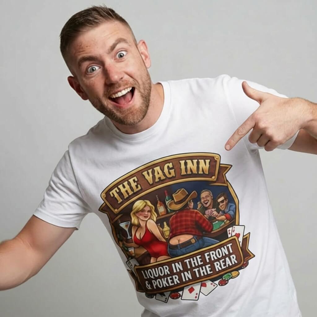A smiling man points at his white The Vag Inn Stag Do Tee, a funny party shirt with a cartoon bar scene and the text: THE VAG INN - LIQUOR IN THE FRONT & POKER IN THE REAR.