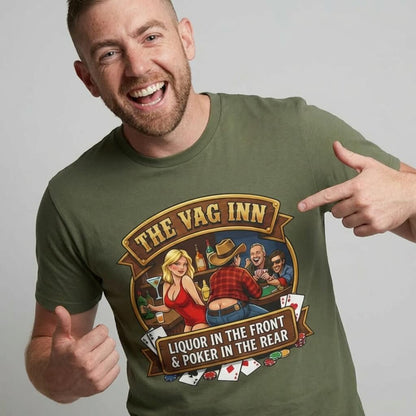 A smiling man points to his green "The Vag Inn Stag Do Tee"—a funny stag party shirt with a cartoon bar scene, playing cards, and the slogan: LIQUOR IN THE FRONT & POKER IN THE REAR.