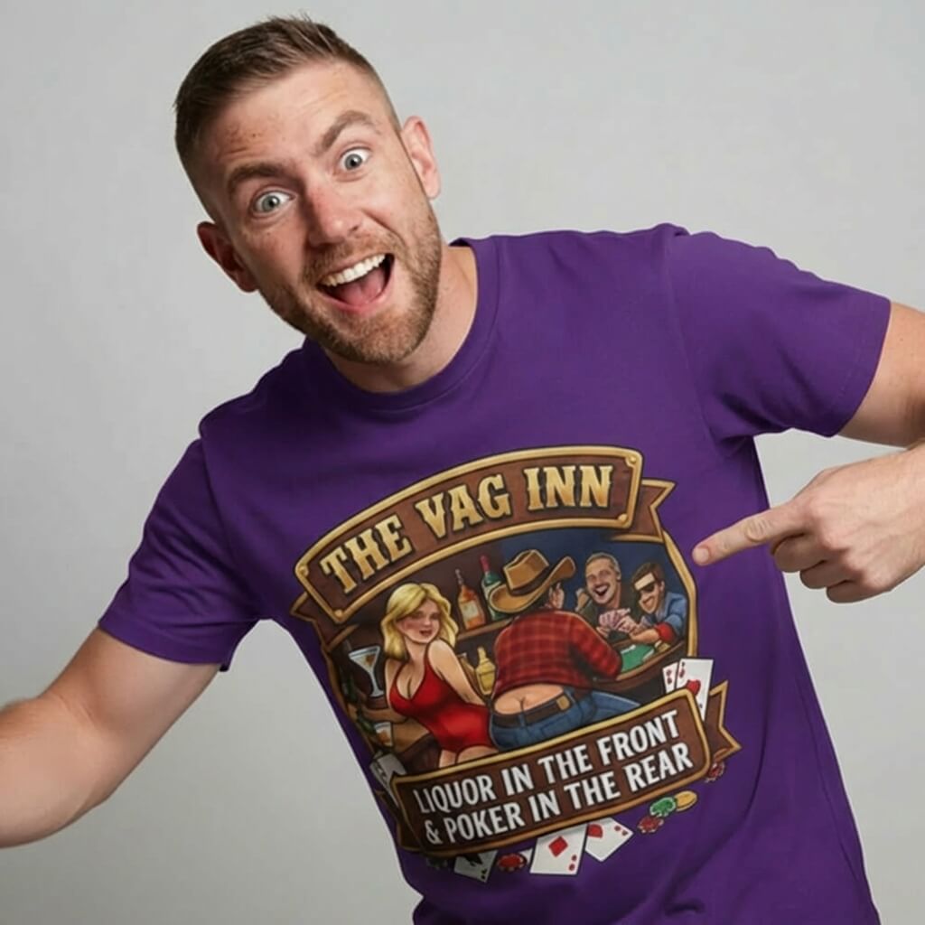 A smiling man proudly points to The Vag Inn Stag Do Tee—a purple shirt featuring a cartoon scene of people playing poker, a woman, and the saying "Liquor in the Front Poker in the Rear." It’s the perfect funny bachelor party shirt.