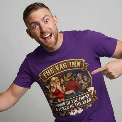 A smiling man proudly points to The Vag Inn Stag Do Tee—a purple shirt featuring a cartoon scene of people playing poker, a woman, and the saying "Liquor in the Front Poker in the Rear." It’s the perfect funny bachelor party shirt.