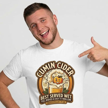 A smiling man shows off his Cumin Cider Stag Do Tee, featuring a frothy cider mug with a playful apple and the text: "Best Served Wet, Full Bodied & Easy to Swallow." The perfect groom gift for any stag do!.