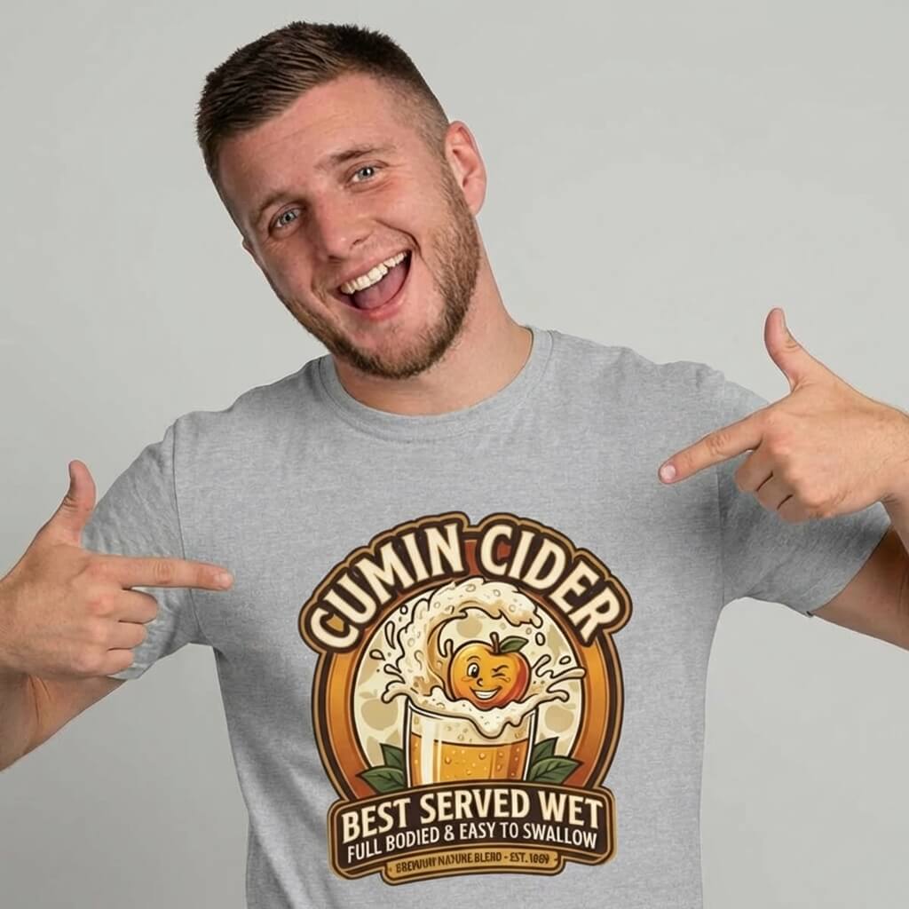 A smiling man points to his Cumin Cider Stag Do Tee, featuring a cartoon cider glass with a happy face and the text "Cumin Cider - Best Served Wet - Full Bodied & Easy to Swallow." A funny groom gift for any stag do.