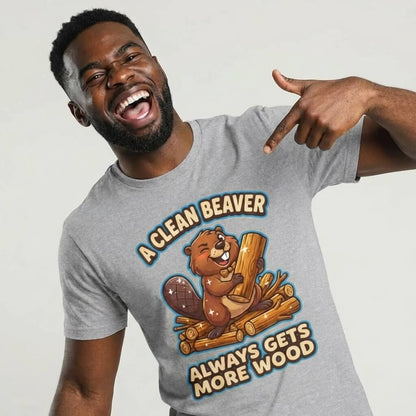 A smiling man points to his "A Clean Beaver Always Gets More Wood" Stag Do Tee, a gray t-shirt featuring a cartoon beaver holding wood and the cheeky slogan.