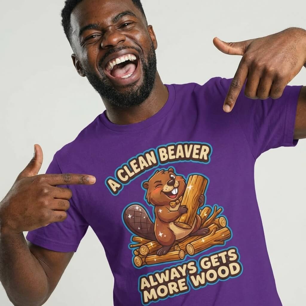 A smiling man wears the "A Clean Beaver Always Gets More Wood" Stag Do Tee, featuring a cartoon beaver with logs and playful text—an ideal choice for anyone searching for fun and cheeky stag do shirt ideas.