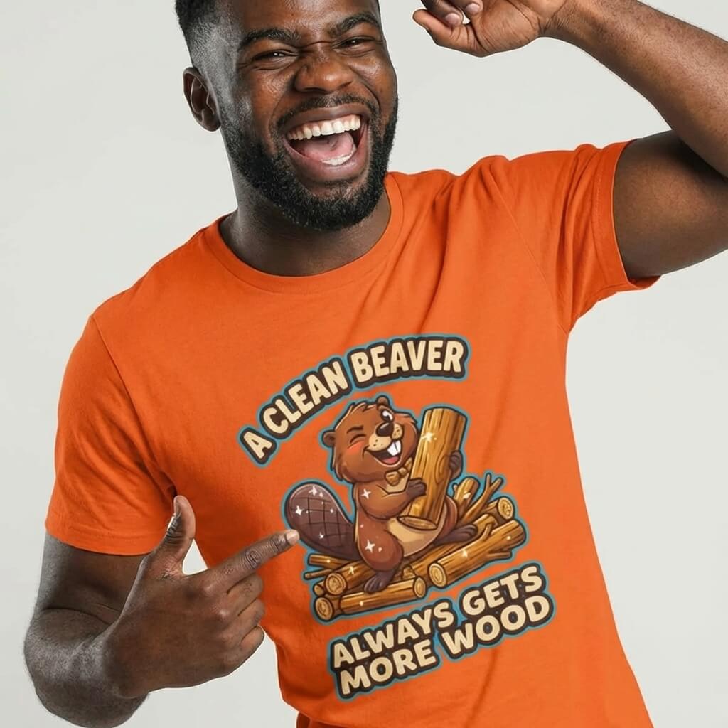 A man smiles in the "A Clean Beaver Always Gets More Wood" Stag Do Tee, a funny orange t-shirt with a cartoon beaver—ideal for matching stag do outfits and adding humor to your celebration.