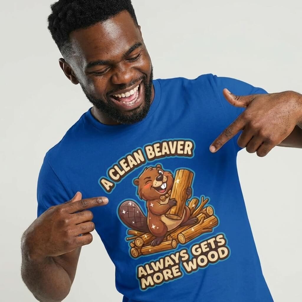 A man points at the "A Clean Beaver Always Gets More Wood" Stag Do Tee featuring a cartoon beaver with logs and funny text—a perfect, blue stag do shirt for matching outfits.