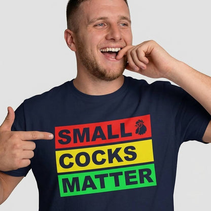 A smiling man in a navy shirt points to the slogan "SMALL COCKS MATTER," making this Small Cocks Matter Stag Do Tee ideal for anyone who loves funny body confidence t-shirts and stag do humour shirts.