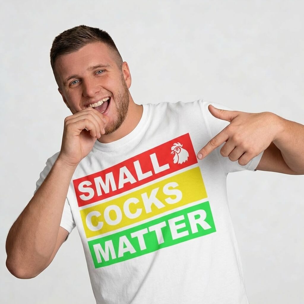 A grinning man shows off his Small Cocks Matter Stag Do Tee, which has bold colorful text and a rooster icon—making this funny t-shirt a perfect, laughter-filled addition to any bachelor party or stag do collection.