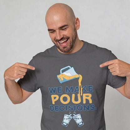 A smiling, bald man points at his "We Make Pour Decisions Stag Do Tee," featuring a tipped pitcher pouring beer and two clinking glasses—an ideal funny drinking shirt for stag dos or pub crawls.
