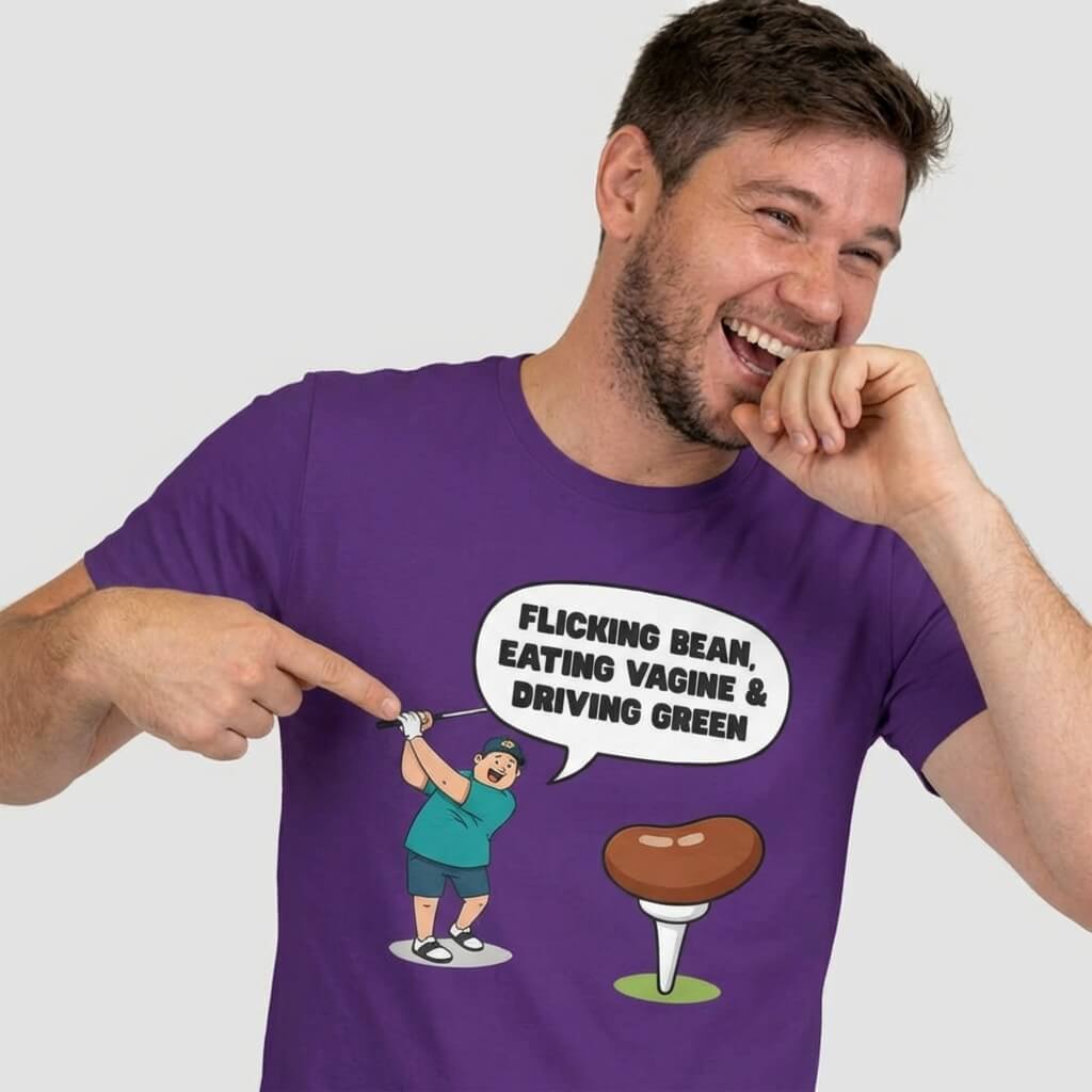 A man laughing and pointing at his "Flicking Bean, Eating Vagine & Driving Green" Tee—a funny golf shirt with a cartoon woman swinging by a huge tee and cheeky slogan. Perfect rude golf t-shirt for any stag do.