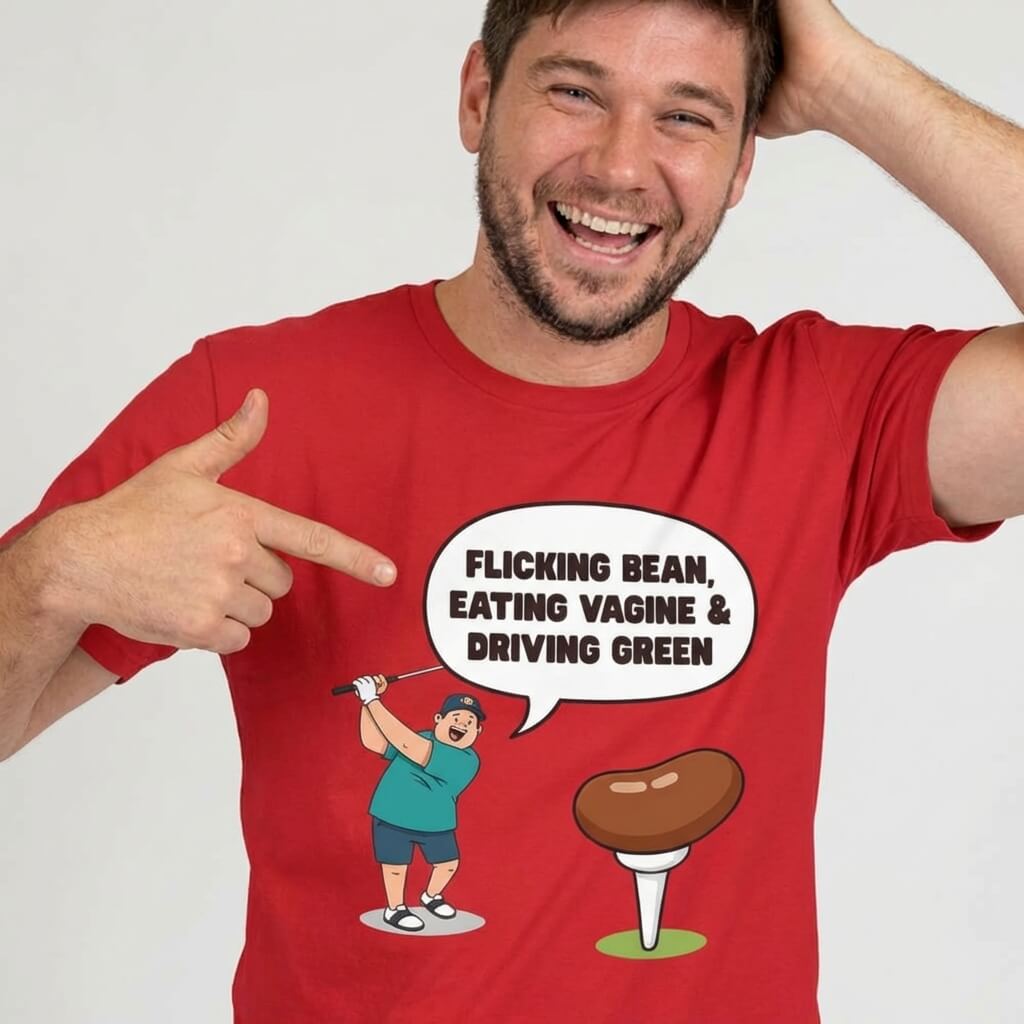 A man smiling and pointing at his "Flicking Bean, Eating Vagine & Driving Green" tee—a red, funny golf shirt with a cartoon golfer, bean-shaped tee, and cheeky slogan. The perfect rude golf t-shirt for your next stag do!.