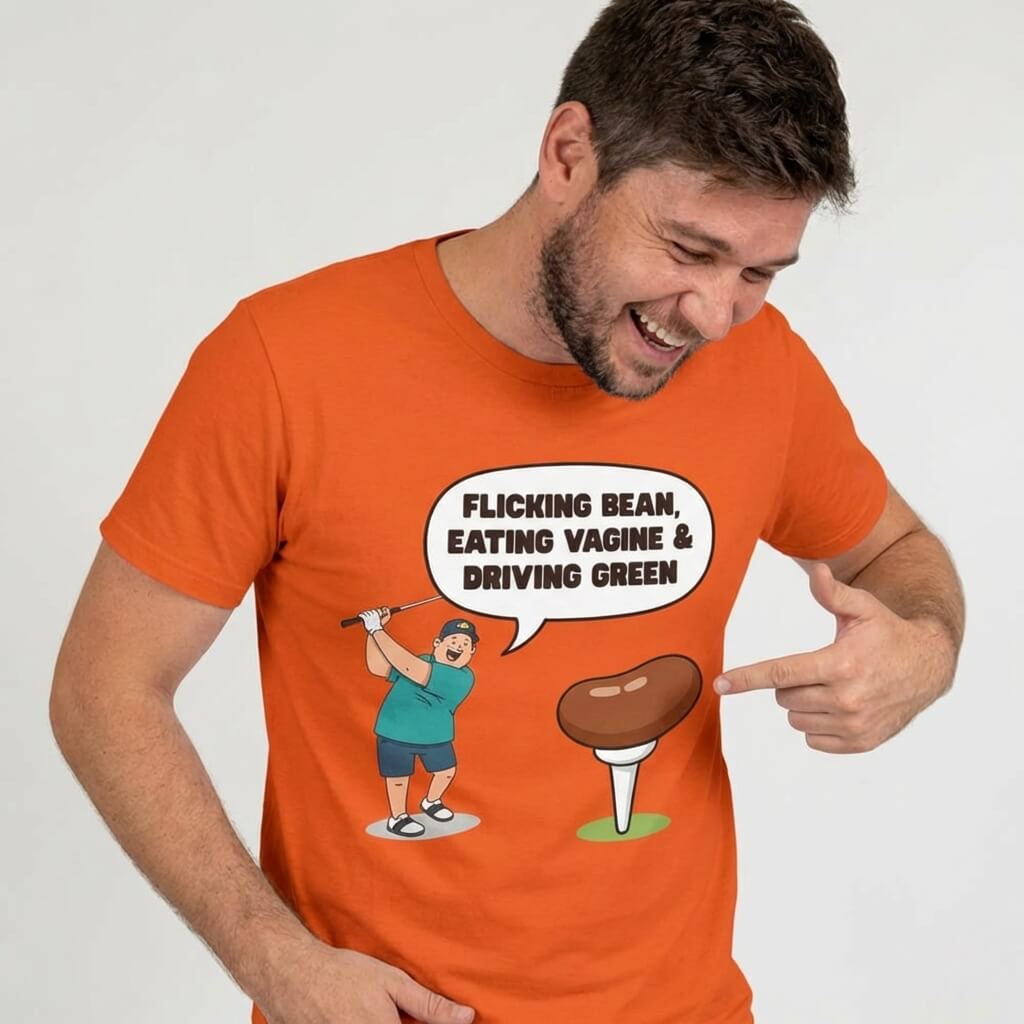 Wearing the "Flicking Bean, Eating Vagine & Driving Green" Tee, a man smiles and points to the cheeky golf cartoon on his shirt. Perfect rude golf t shirt for anyone with a bold sense of humor.