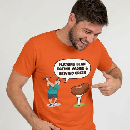 Wearing the "Flicking Bean, Eating Vagine & Driving Green" Tee, a man smiles and points to the cheeky golf cartoon on his shirt. Perfect rude golf t shirt for anyone with a bold sense of humor.