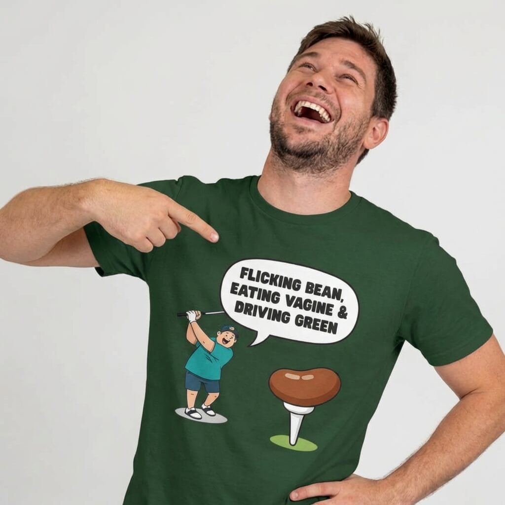 A man laughs and points at his green "Flicking Bean, Eating Vagine & Driving Green" Tee featuring a rude cartoon golfer and golf tee. This funny golf shirt is perfect for stag dos or anyone who loves humor on the course.