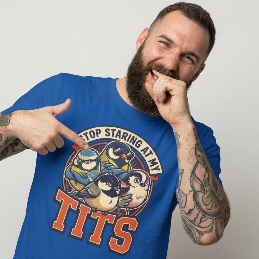 A bearded man points to his “Stop Staring at My Tits” Stag Do Tee, featuring cartoon tit birds and bold text. This funny groom gift or stag do outfit is sure to stand out.