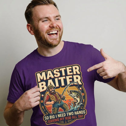 A bearded man points at his Master Baiter Rude Fishing Tee, which features a cartoon fisherman and the text: "MASTER BAITER: So big I need two hands, jerking my rod all day." A hilarious gift for fishing enthusiasts.