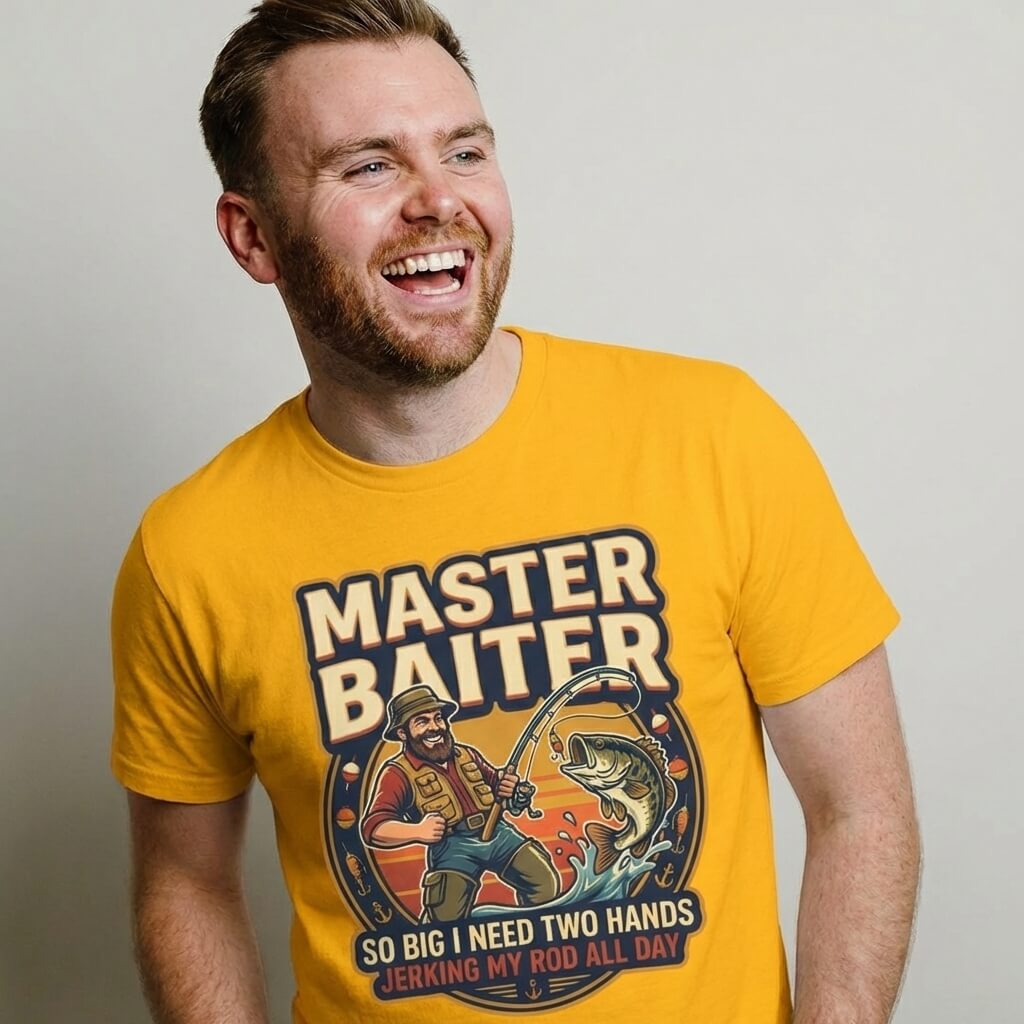 A smiling man wears the Master Baiter Rude Fishing Tee, a bright yellow shirt with a cartoon fisherman and cheeky text—perfect as a funny fishing gift or humorous t-shirt for anyone with a playful sense of humor.