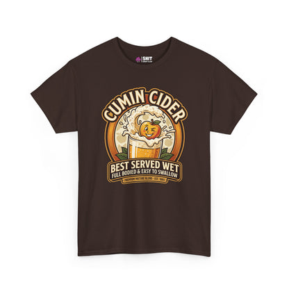The Cumin Cider Stag Do Tee is a dark brown shirt with a cartoon apple splashing in cider, "Cumin Cider" text above, and "Best Served Wet—Full Bodied & Easy To Swallow" below—perfect for stag dos.