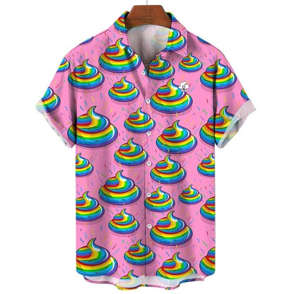 The Unicorn Poo Shirt is a short-sleeved, button-up shirt with a pink background, featuring rainbow poop emojis and sprinkles in a fun all-over print. Displayed on a wooden hanger.