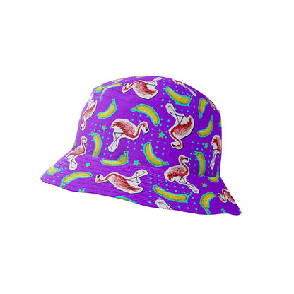 The Bananas For Flamingos Bucket Hat features a purple base adorned with playful pink flamingos, green bananas, and blue stars for a fun, vibrant look.