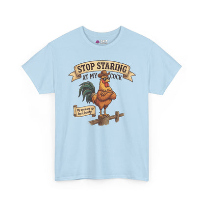 The Stop Staring at My Cock Stag Do Tee features a light blue design with a cartoon rooster on a fence and playful text, making it the perfect funny shirt for stag parties or grooms.