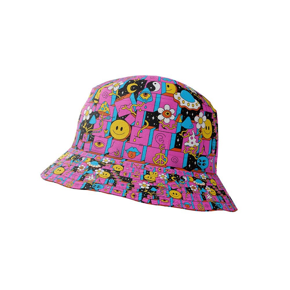 The Trippy Space Shirt features a bright pink base, playful cartoon graphics, smiley faces, peace signs, and an electric blue pattern with stars, flowers, music notes, hearts, mushrooms, and yin-yang symbols.