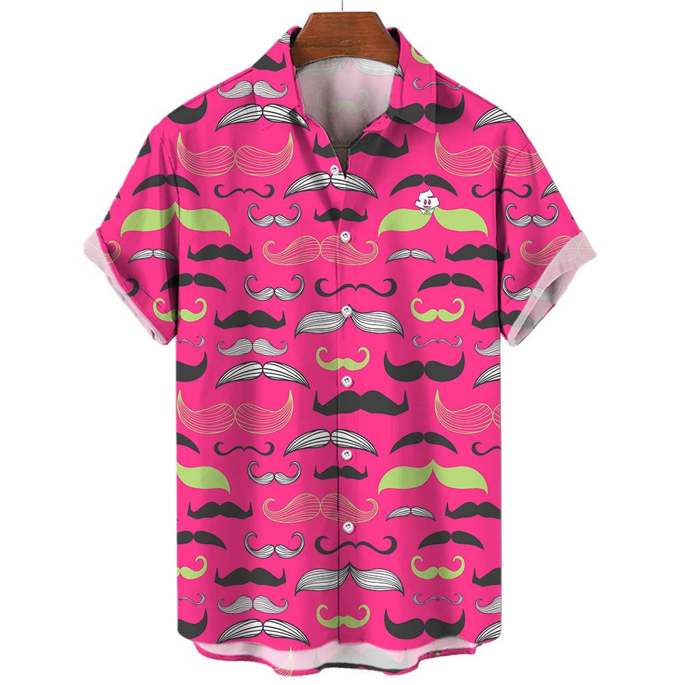 The Movember Shirt is a short-sleeve, button-up with a bright pink background and black, white, and green moustache patterns. A fun cartoon face with a moustache peeks from the pocket—ideal as a statement or Movember shirt.