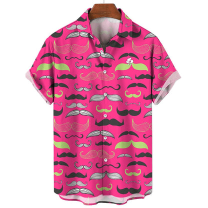 The Movember Shirt is a short-sleeve, button-up with a bright pink background and black, white, and green moustache patterns. A fun cartoon face with a moustache peeks from the pocket—ideal as a statement or Movember shirt.