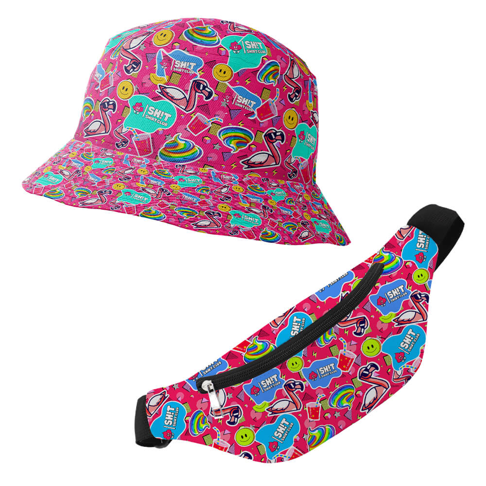 The Badass Bucket Hat is a vibrant festival accessory adorned with a bright pink pattern featuring flamingos, rainbows, smiley faces, and blue SH*T HAPPENS speech bubbles.