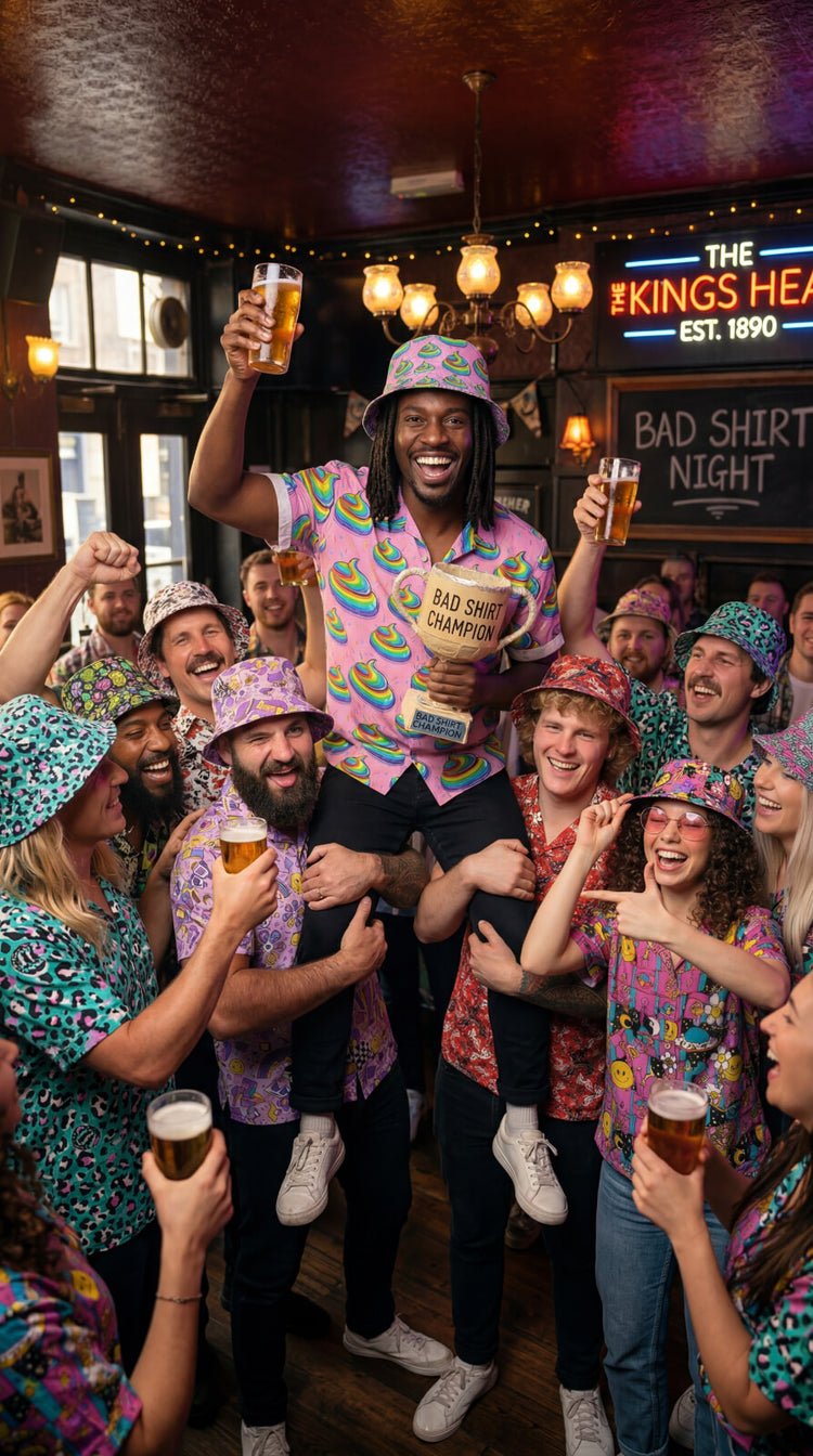 Group of people in a pub celebrating a Bad Shirt Club, with one person holding a trophy and others cheering wearing shit shirts.