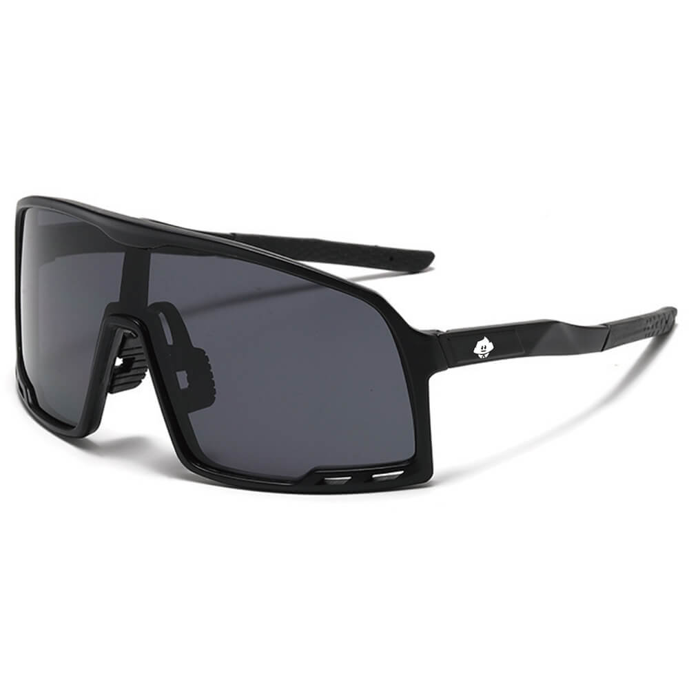 Send It Shades are black rectangular shield sunglasses with thick frames, dark tinted lenses, and a logo on the temple. Their modern angular design is ideal for outdoor or athletic use. Shown on a plain white background.