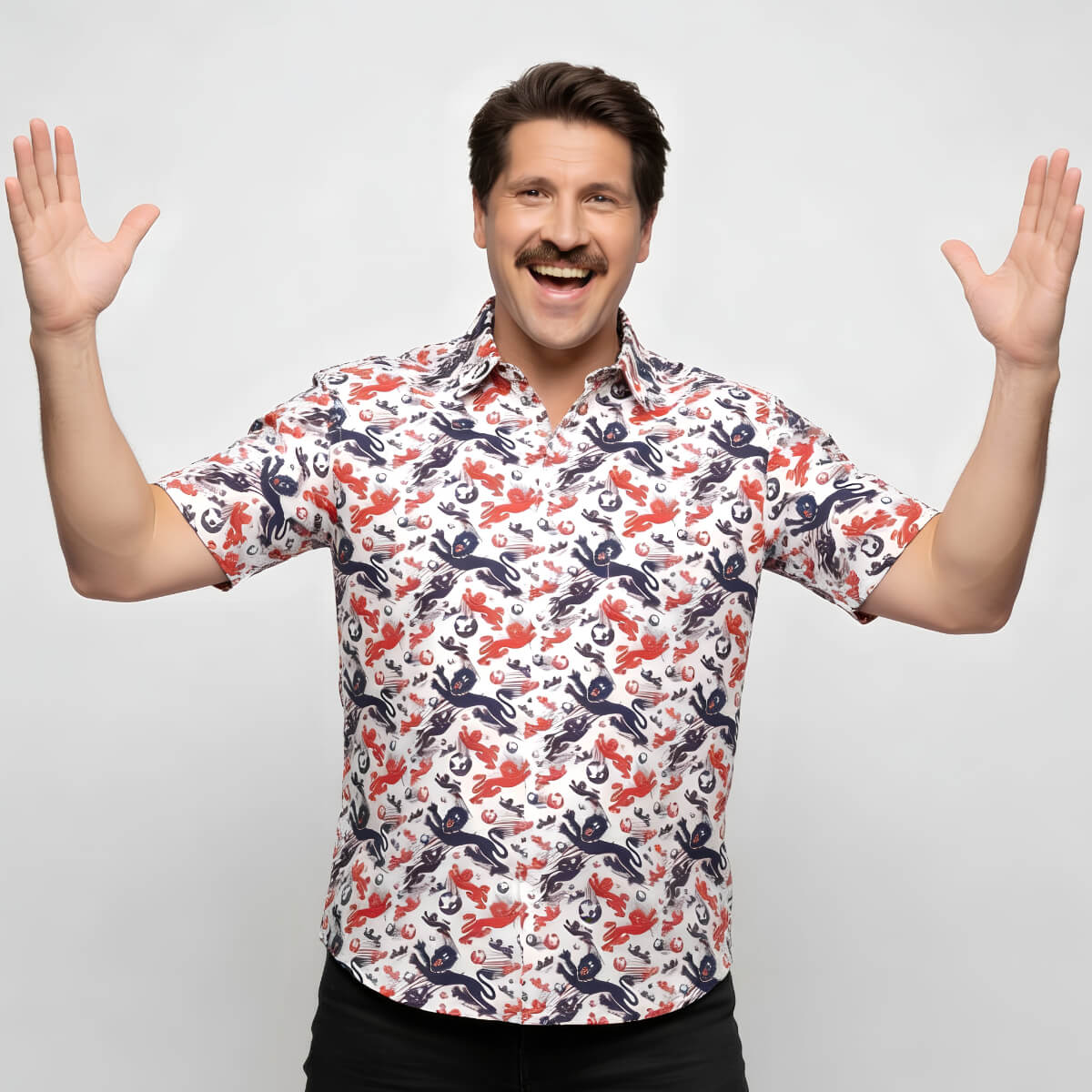 A smiling man with a mustache raises both hands enthusiastically, wearing an England Football Hawaiian Shirt featuring a vibrant red and blue crab and octopus print on a white background.