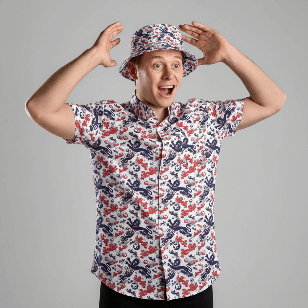 Person wearing the England Football Hawaiian Shirt and matching bucket hat against a grey background 