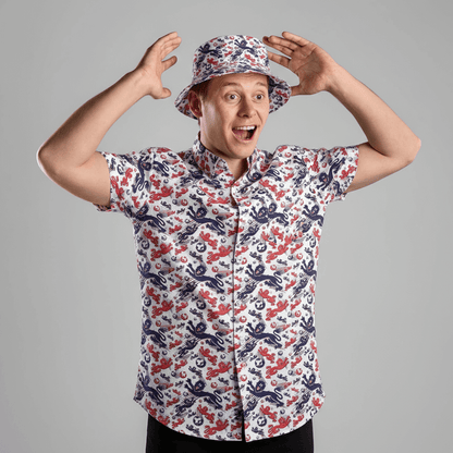 Person wearing the England Football Hawaiian Shirt and matching bucket hat against a grey background 