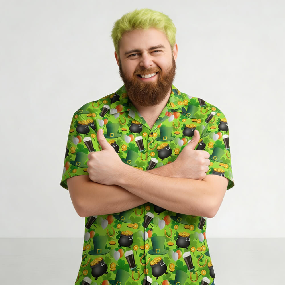 A smiling man with light green hair and a beard stands against a plain background, wearing the St Patrick's Day Shirt. His arms are crossed, and he gives two thumbs up.