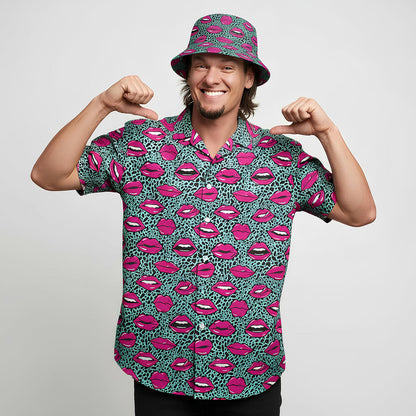 A cheerful man in a matching shirt and bucket hat with vibrant lips print proudly shows off his Leopard Kiss Bad Shirt against a plain white background—a true statement piece.