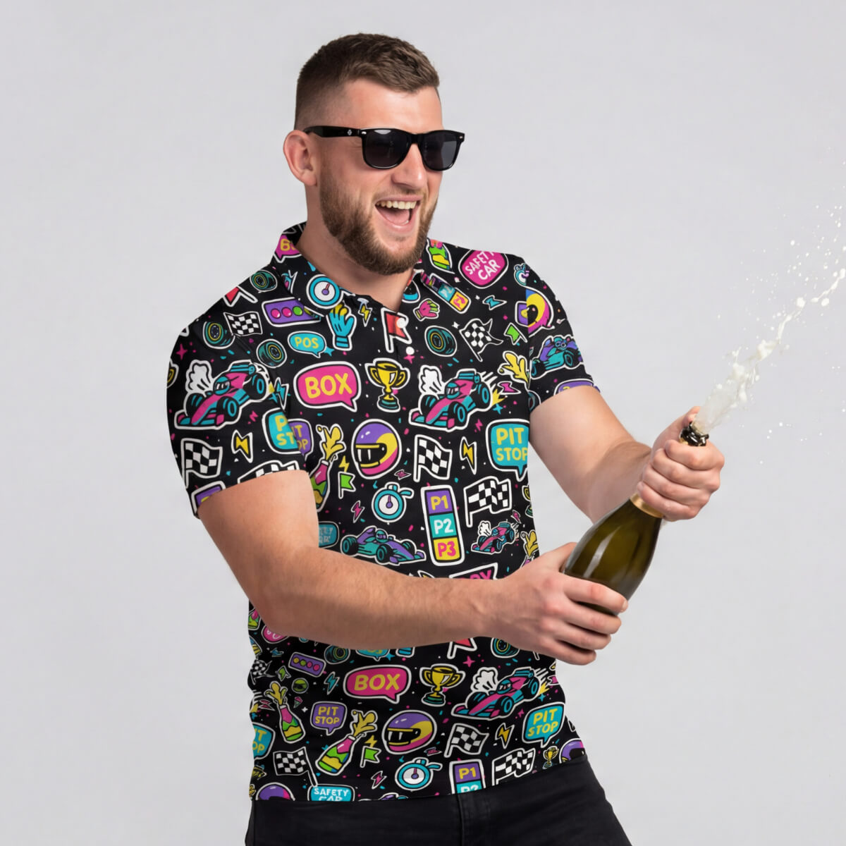 A man in sunglasses smiles and pops a bottle of champagne, spray flying, while wearing the DRS To Impress F1 Polo Shirt.