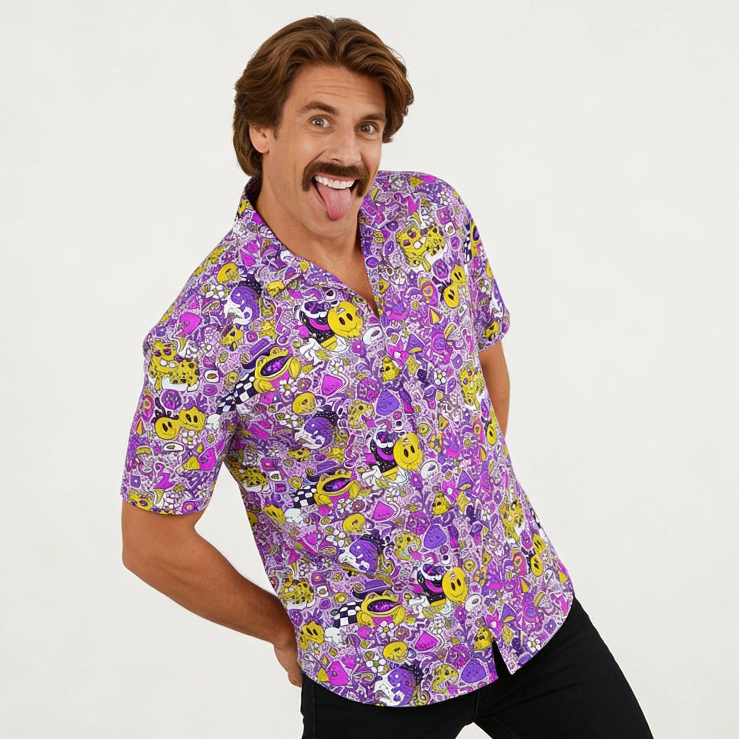 A playful man with brown hair and a mustache smiles and sticks out his tongue while wearing the Magical Psychedelic Shirt, a colorful fashion top with cartoon faces, smiley emojis, and vibrant designs on a white background.
