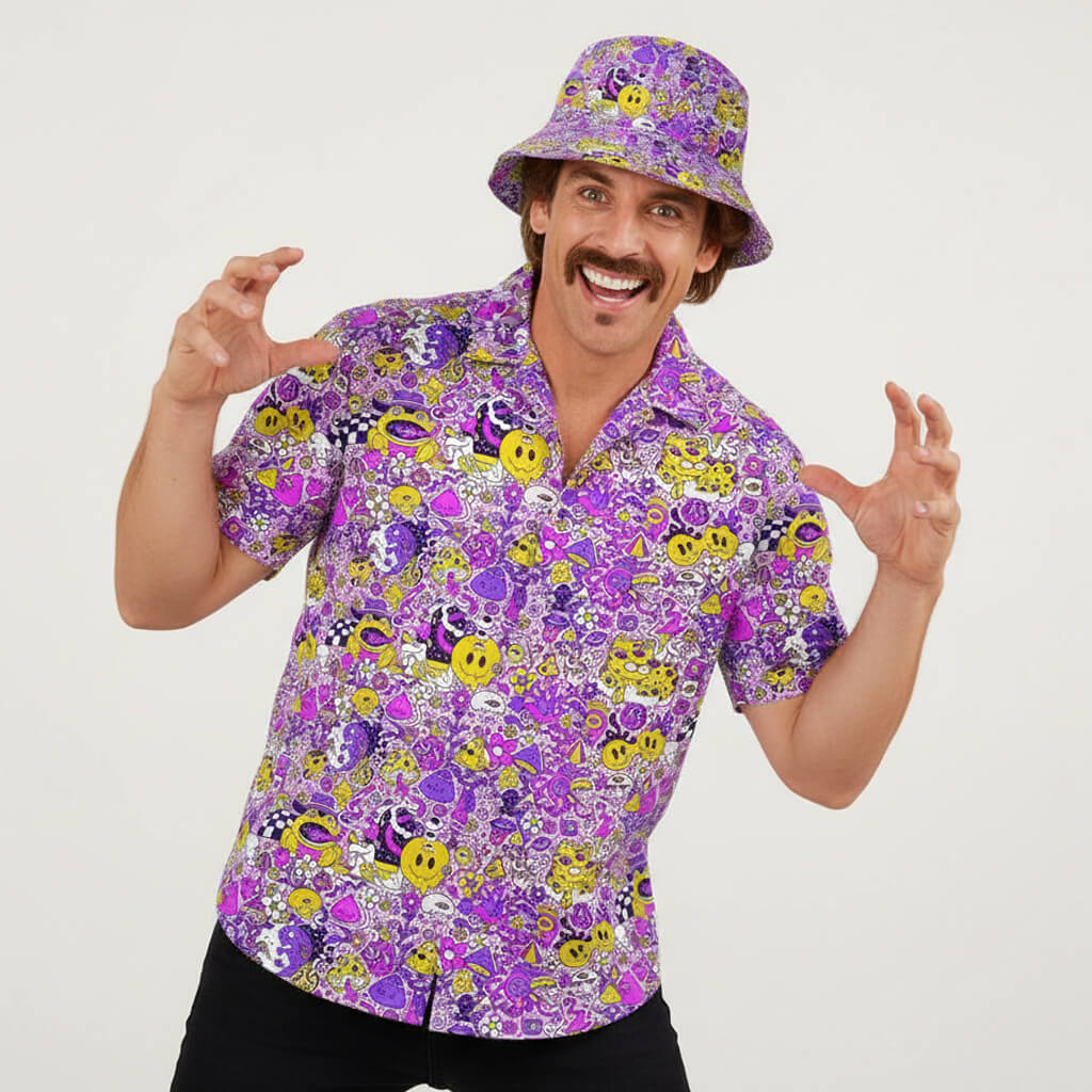 A man with a mustache wears the Magical Psychedelic Shirt and a vibrant purple bucket hat, both featuring cartoon and smiley face patterns, playfully raising his hands like a monster against a plain white background.