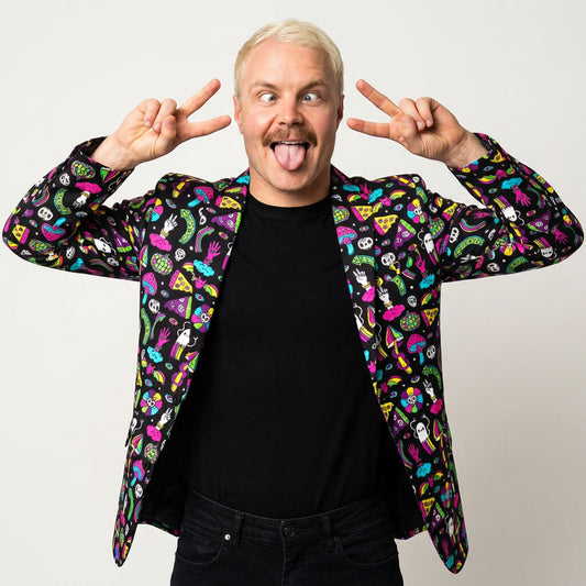 A blonde man in the Shroom Blazer and a black shirt poses playfully, sticking out his tongue and flashing peace signs with both hands against a plain white background.