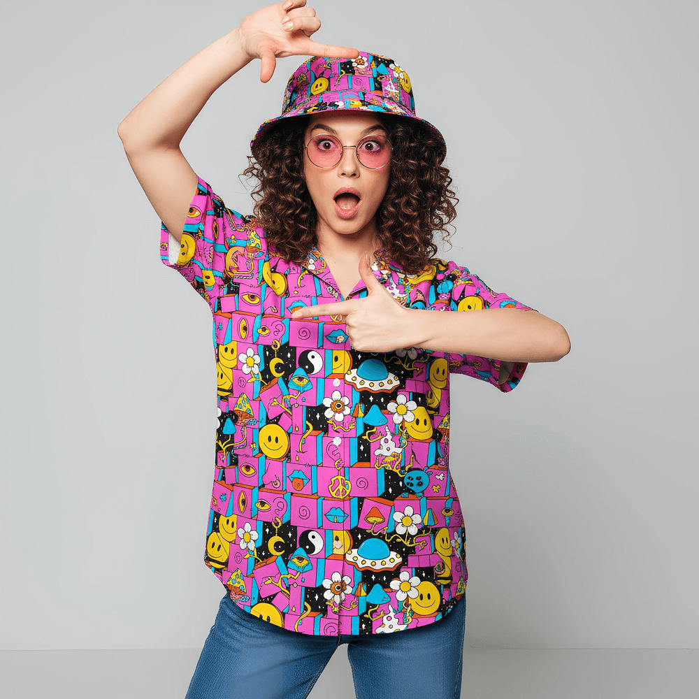 Woman wearing the Trippy Space Shirt, matching Trippy Space Bucket Hat, and pink sunglasses, on a grey background