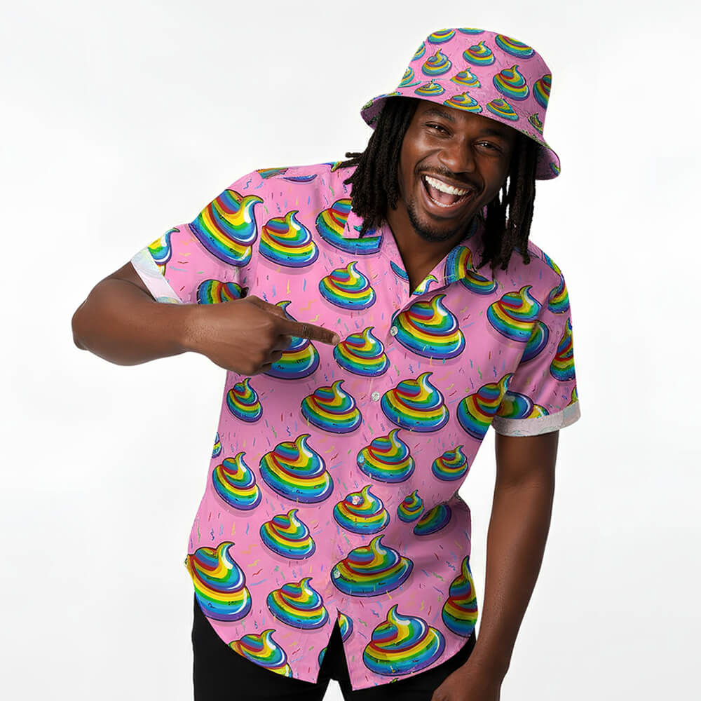 A smiling man wears a matching pink shirt and the Unicorn Poo Bucket Hat, both featuring colorful rainbow poop emoji designs. He points at his shirt while standing against a plain white background.