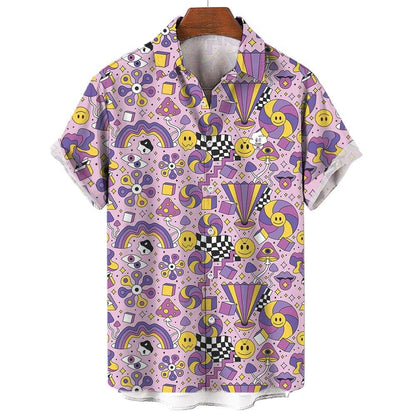 The Hippie Shirt is a short-sleeve top with a vibrant, abstract pattern of smiley faces, rainbows, checkerboards, swirls, stars, and geometric shapes in purple, yellow, pink, and black on a light background.