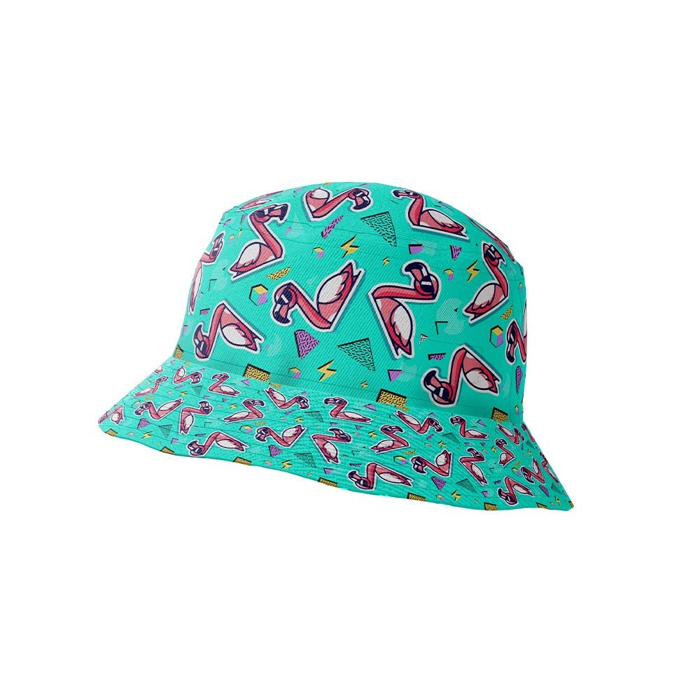 The Flamingo Fandango Bucket Hat showcases pink flamingos, geometric shapes, and colorful squiggles in a vibrant, retro-inspired design. Its wide brim and playful pattern make it perfect for festivals and sunny days.