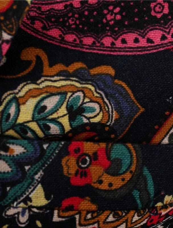 Close-up of the Navy Floral Blazer’s colorful, intricate paisley and floral patterns on dark fabric in shades of pink, orange, teal, green, and yellow—ideal for a bold men’s look or standout suit jacket with detailed designs.